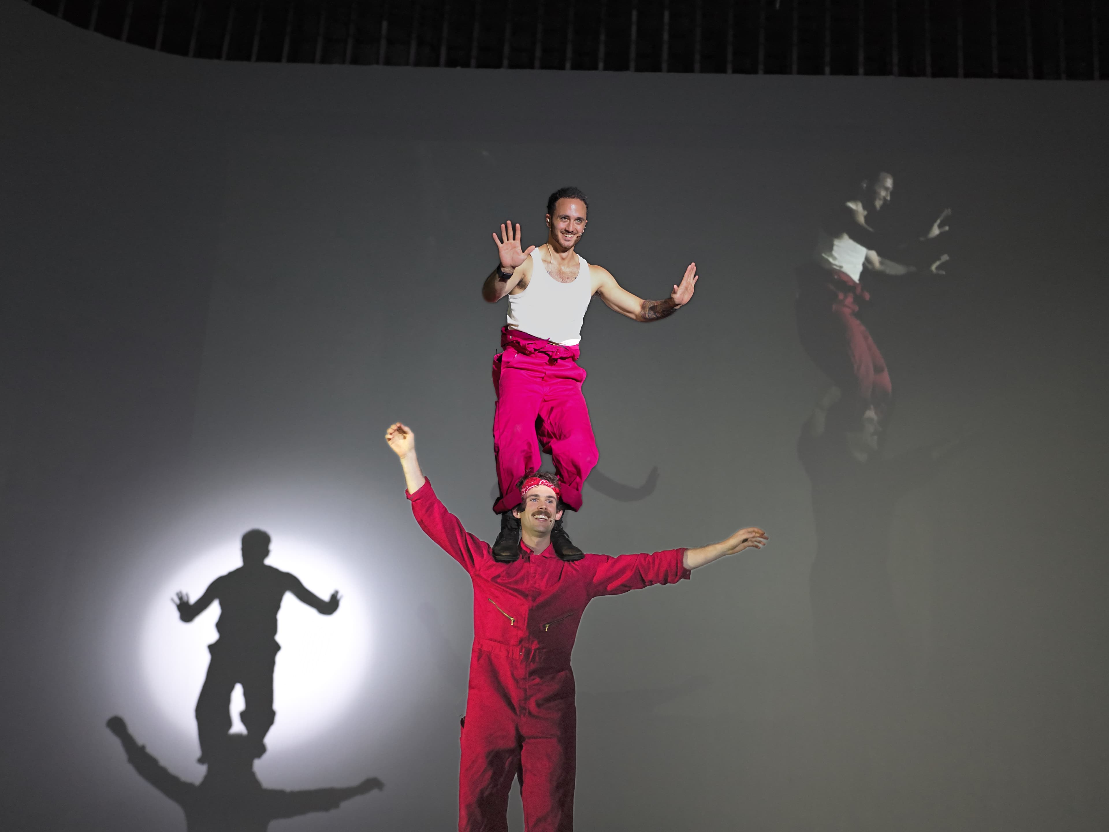 Two performers balancing on stage