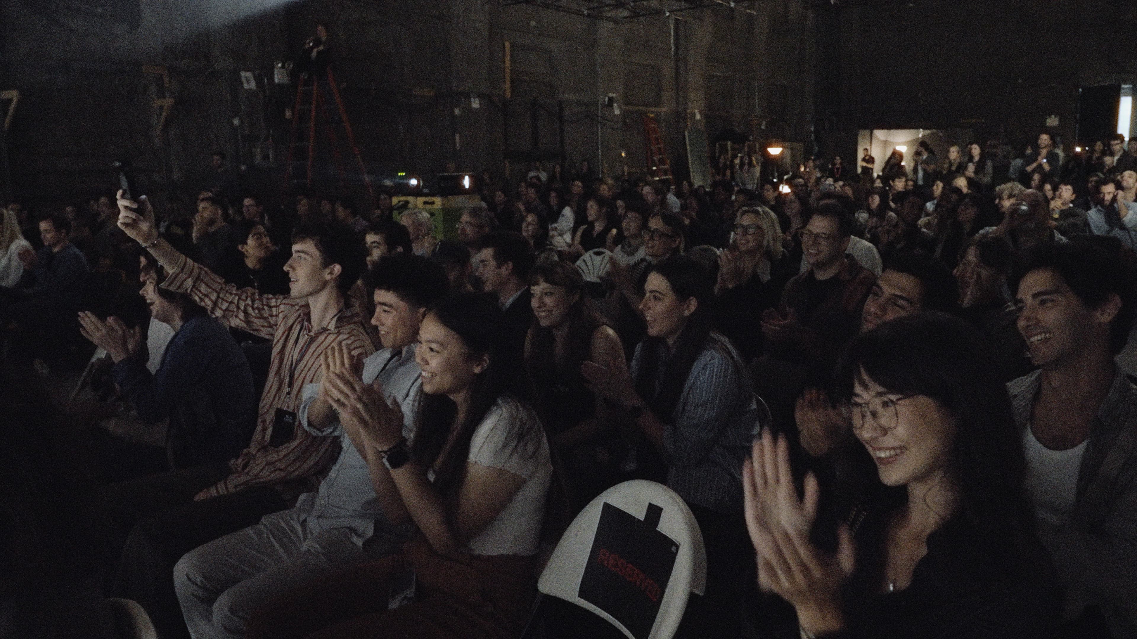 The audience smiling and applauding