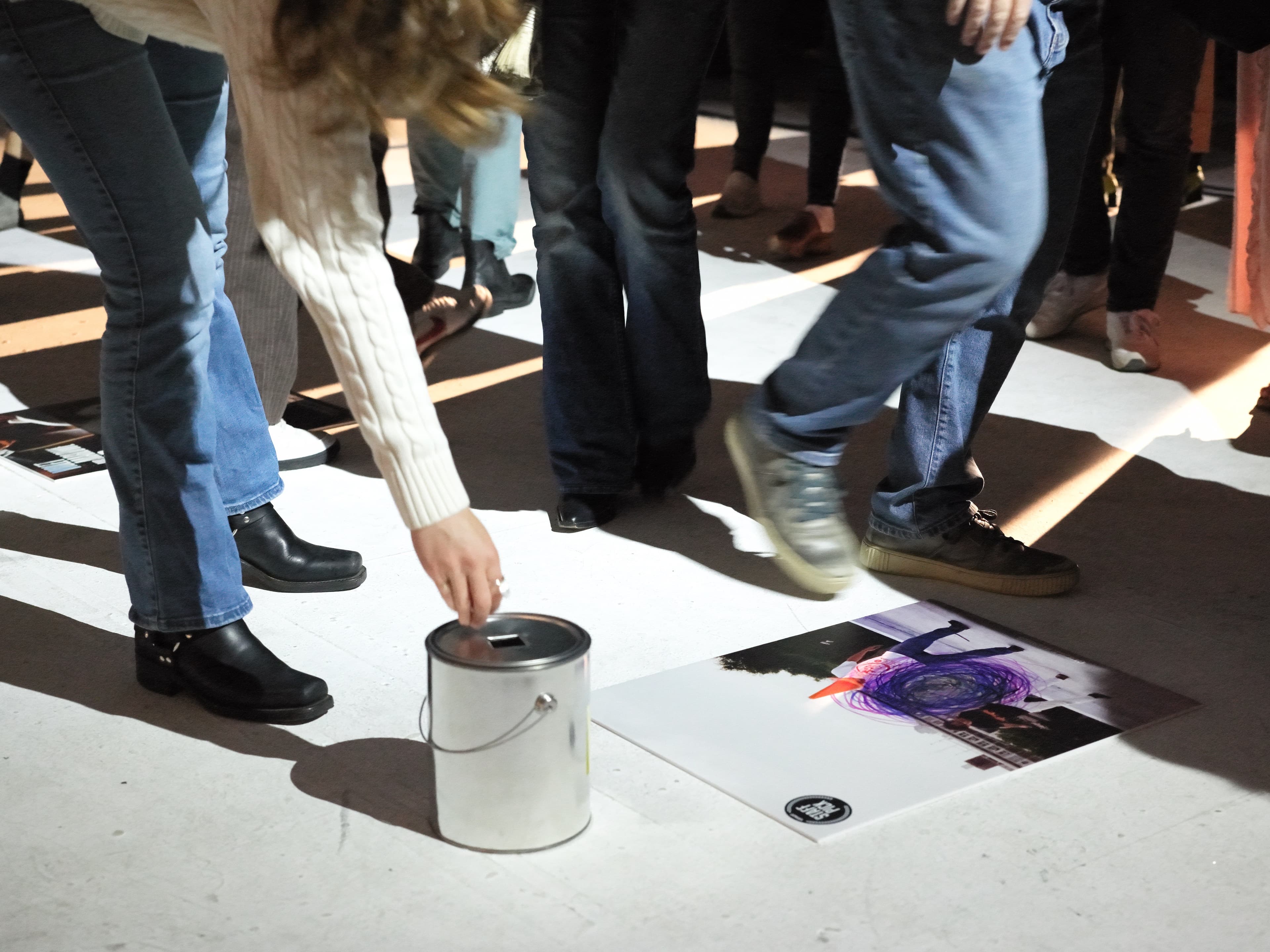 An audience member casting a marble vote for their favorite film
